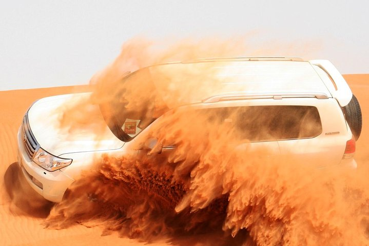 Experience the excitement of dune bashing in a luxurious 4WD gliding through golden sand as you enjoy unforgettable moments in the Dubai desert. Adventure awaits under the stars!